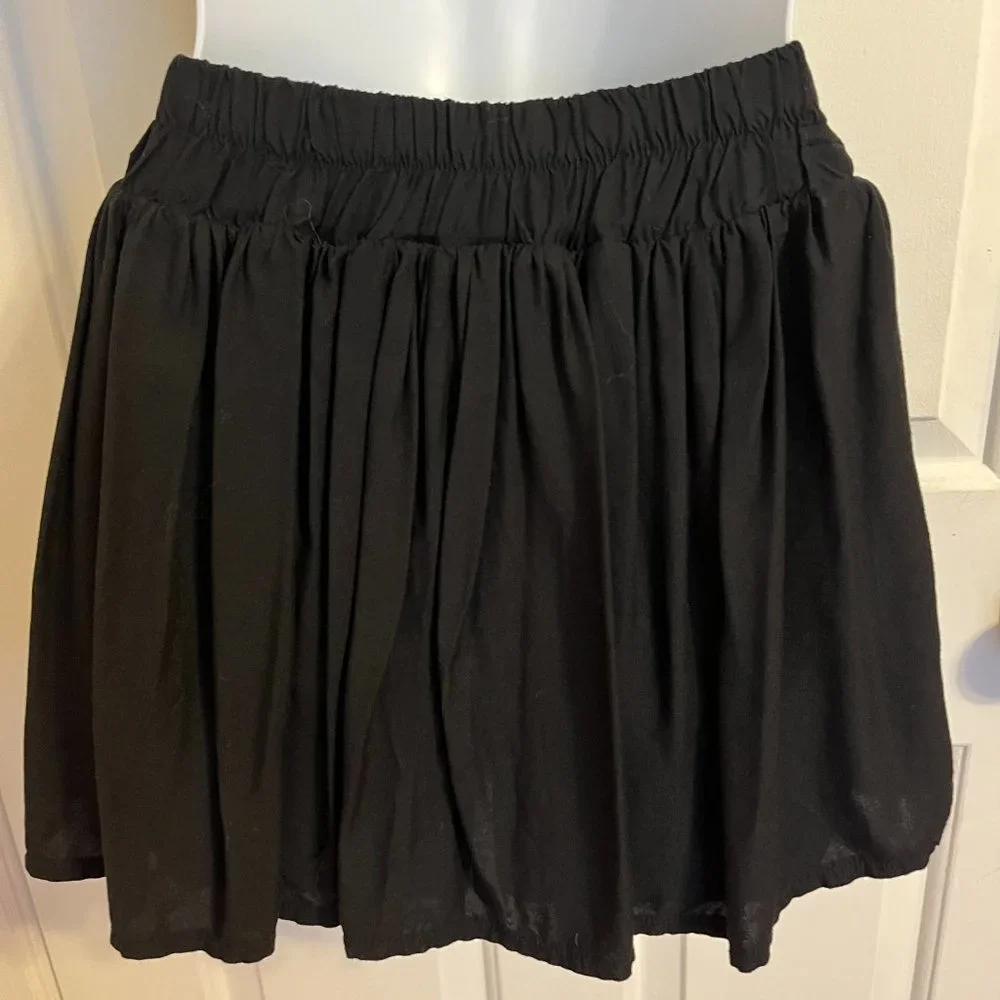 Justice black skort with silver sparkly trim along waistline and hem sz 12